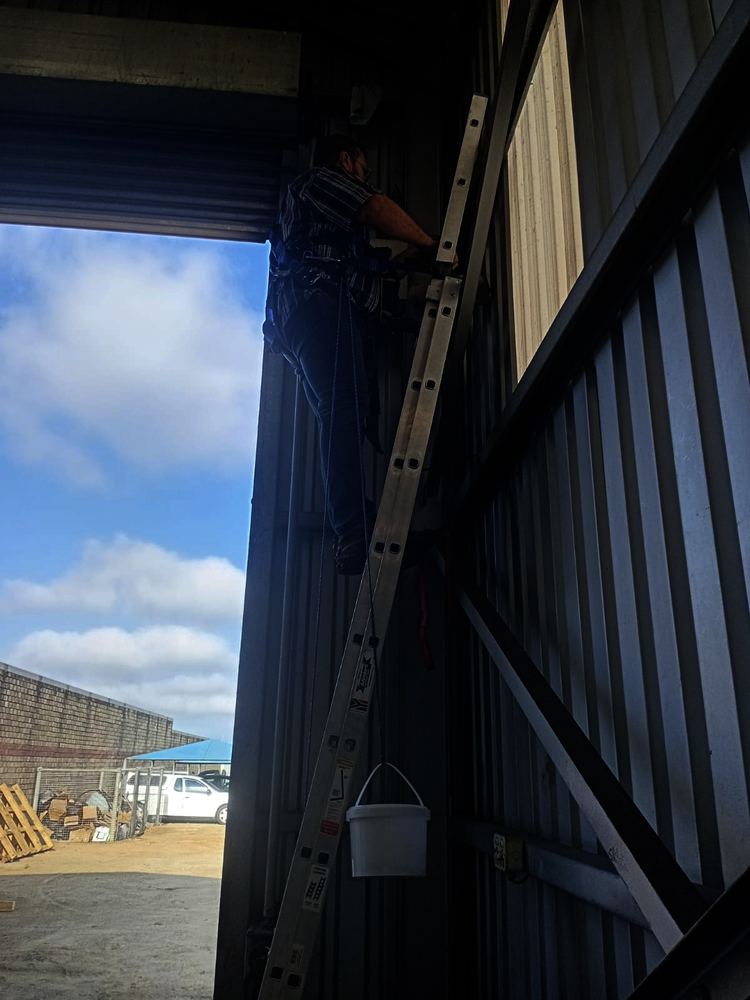 Working at height on an extension ladder with a safety harness