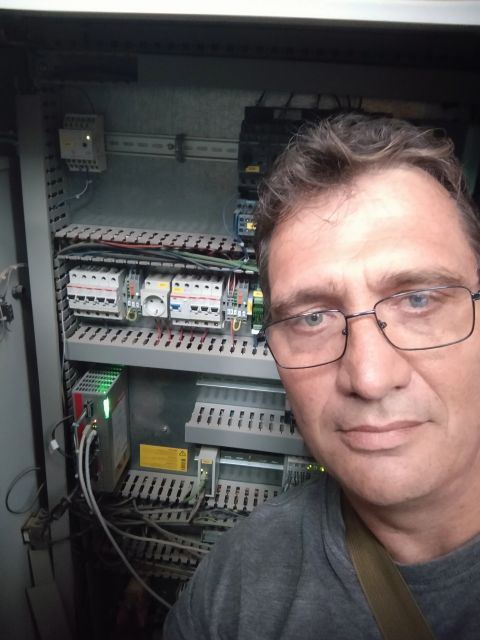 Andre working inside an electrical and control panel